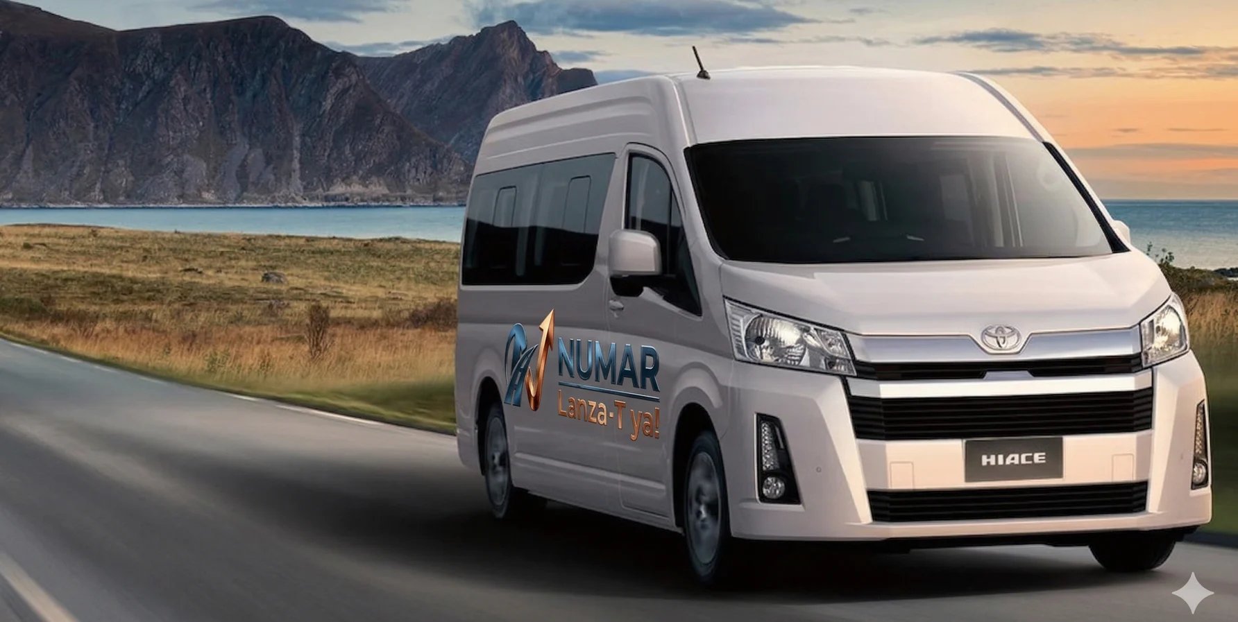 White Toyota Hiace van with Kumar branding driving on coastal road with rocky mountains and ocean in background